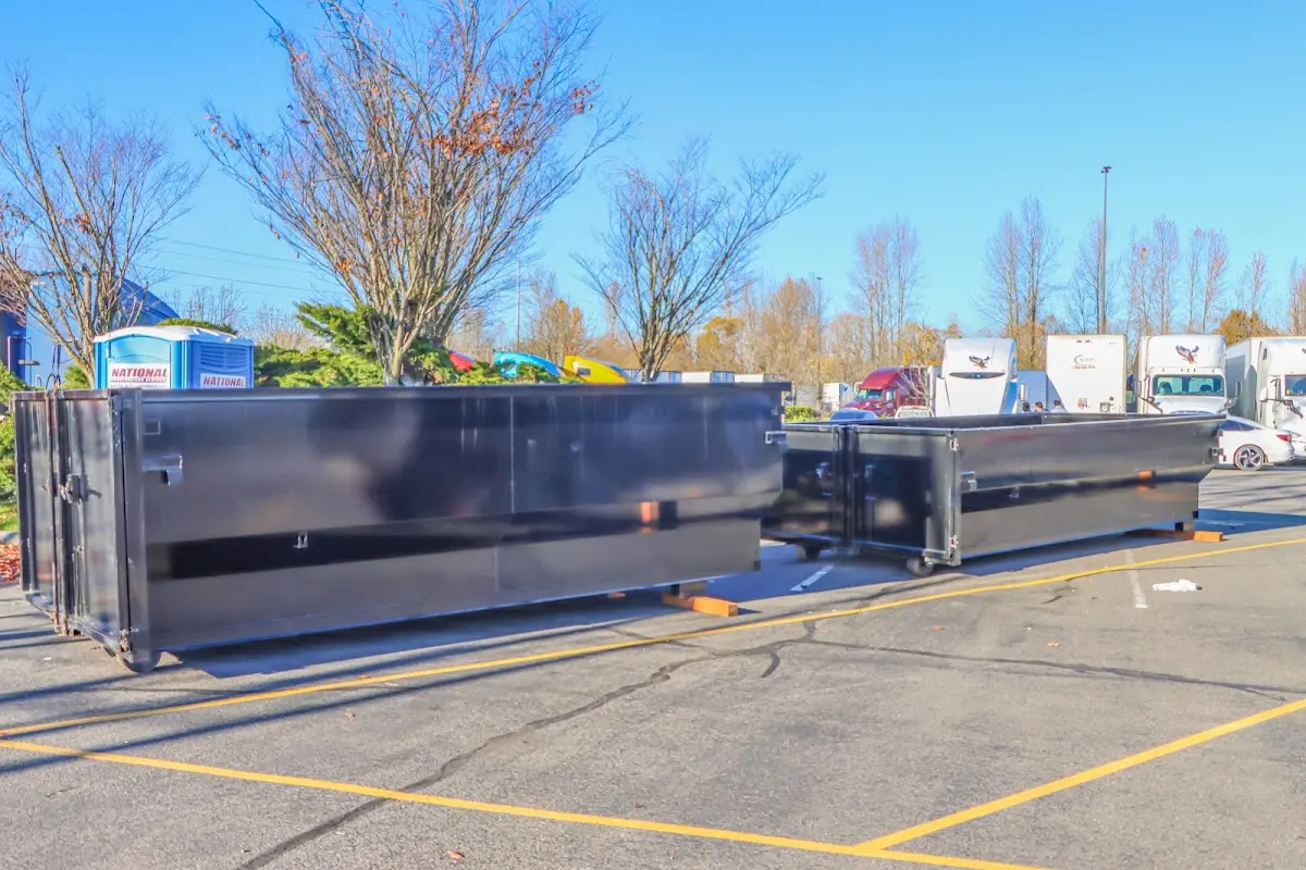 Professional dumpster rental service with roll-off container on residential driveway in Clarks Summit